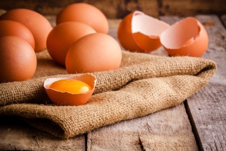 Fresh farm eggs on a wooden rustic background