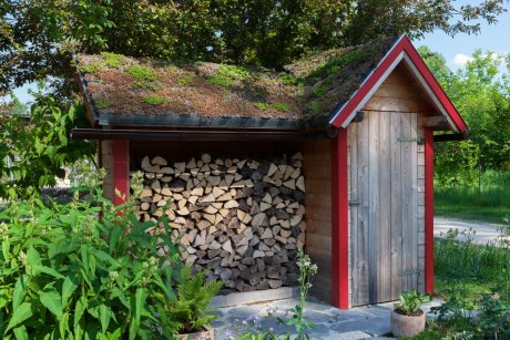 Small hut in the garden with firewood