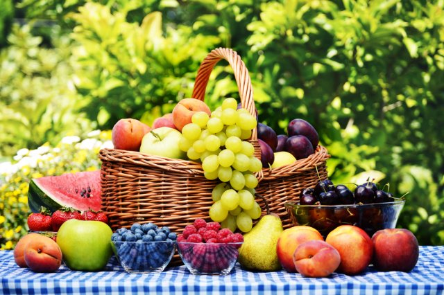 Basket of fresh organic fruits in the garden